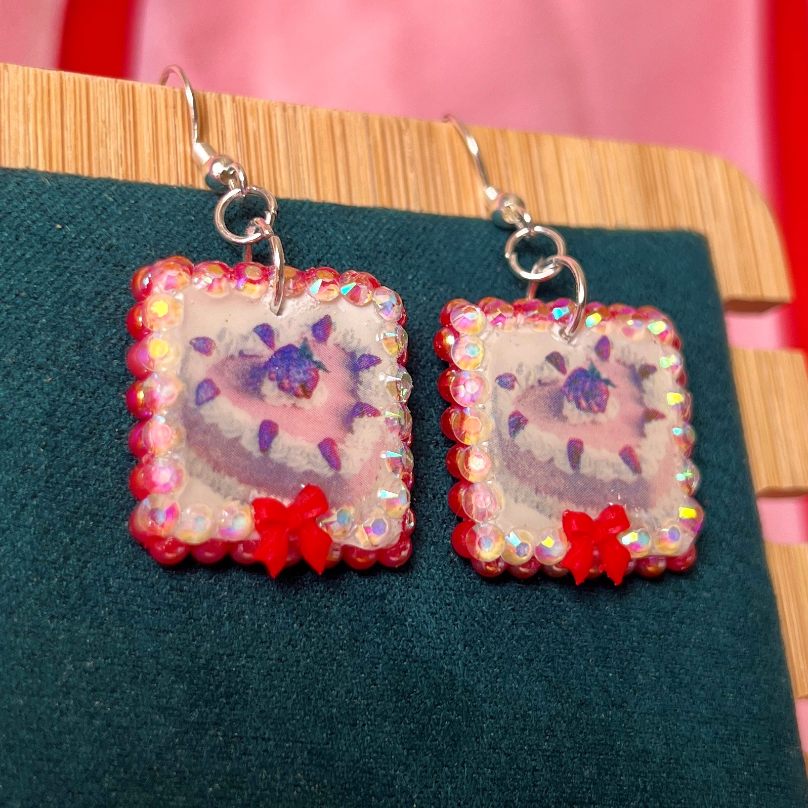 Handmade strawberry cake and bow earrings — polymer‑clay charm, iridescent pearls, rhinestones, silver‑plated hypoallergenic hooks; sweet coquette, kawaii, pastel, Y2K dessert jewelry.