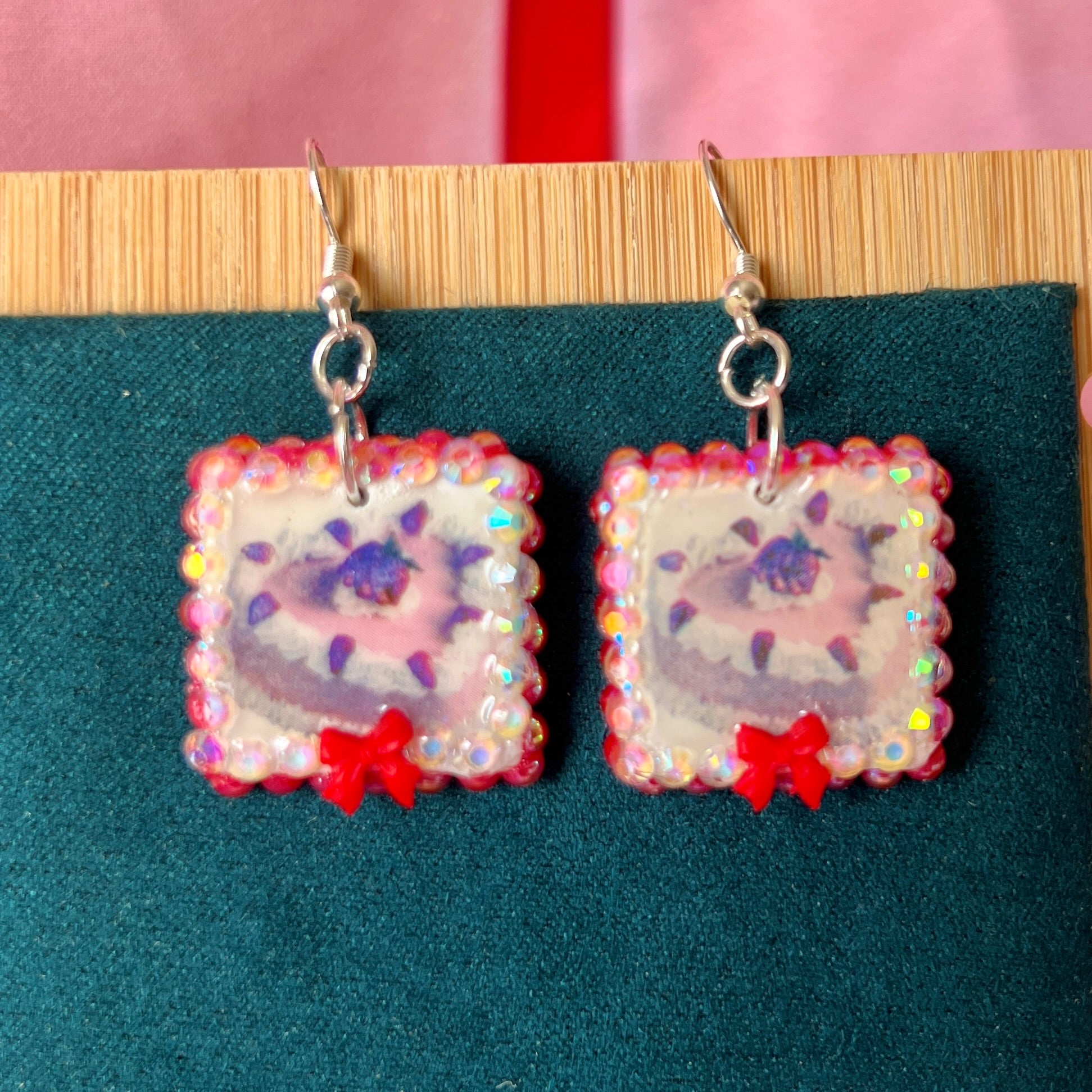 Handmade strawberry cake and bow earrings — polymer‑clay charm, iridescent pearls, rhinestones, silver‑plated hypoallergenic hooks; sweet coquette, kawaii, pastel, Y2K dessert jewelry.