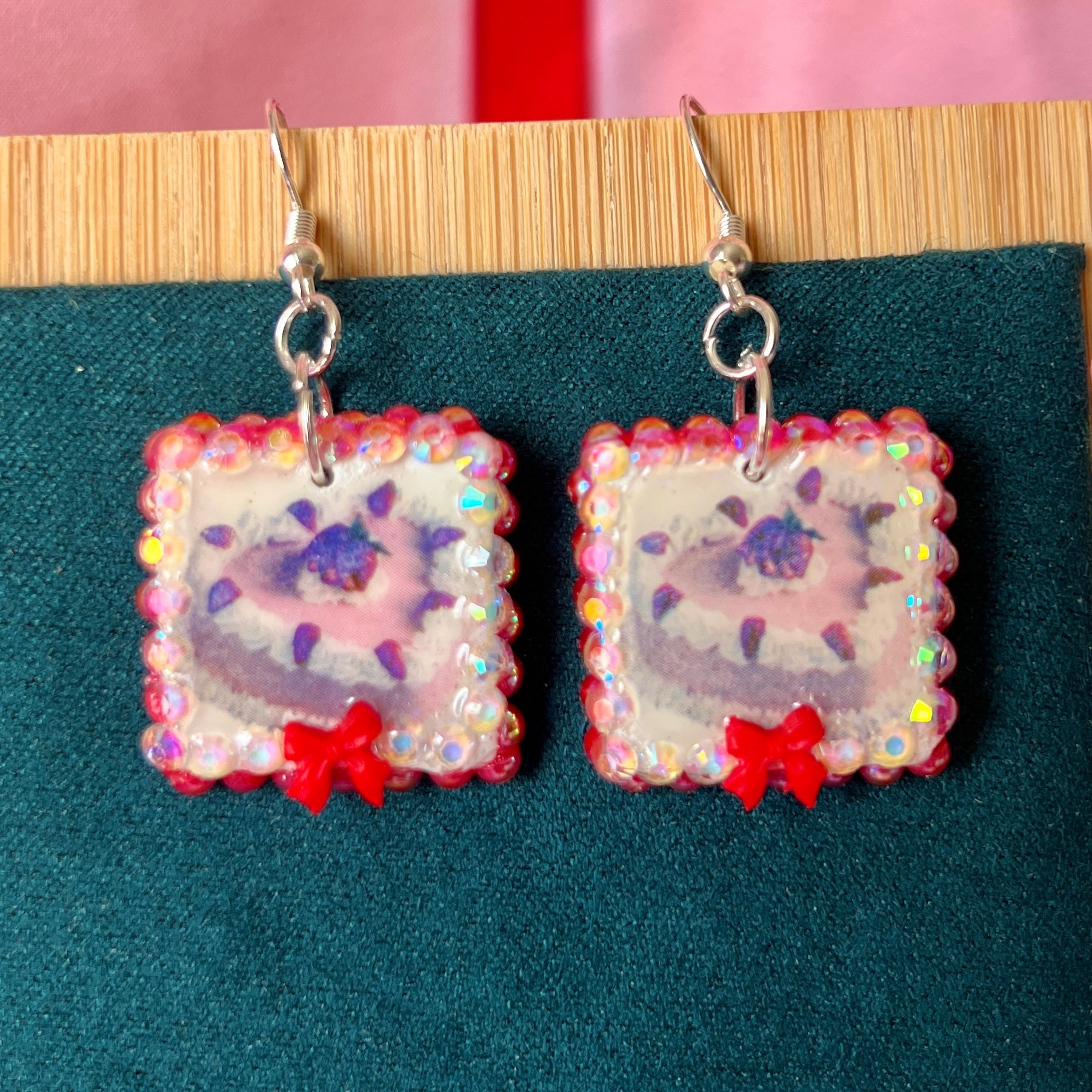 Handmade strawberry cake and bow earrings — polymer‑clay charm, iridescent pearls, rhinestones, silver‑plated hypoallergenic hooks; sweet coquette, kawaii, pastel, Y2K dessert jewelry.