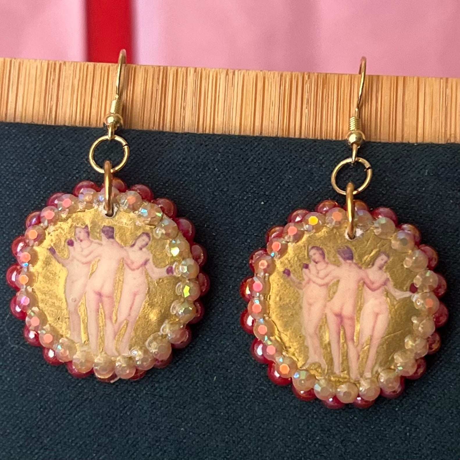 Handmade Three Graces gold earrings: metallic gold‑painted polymer clay framed with iridescent pearls and rhinestones, featuring hypoallergenic 18k gold‑plated hooks—perfect fairy‑core, goddess‑core, statement piece for lovers of Greek mythology jewelry.