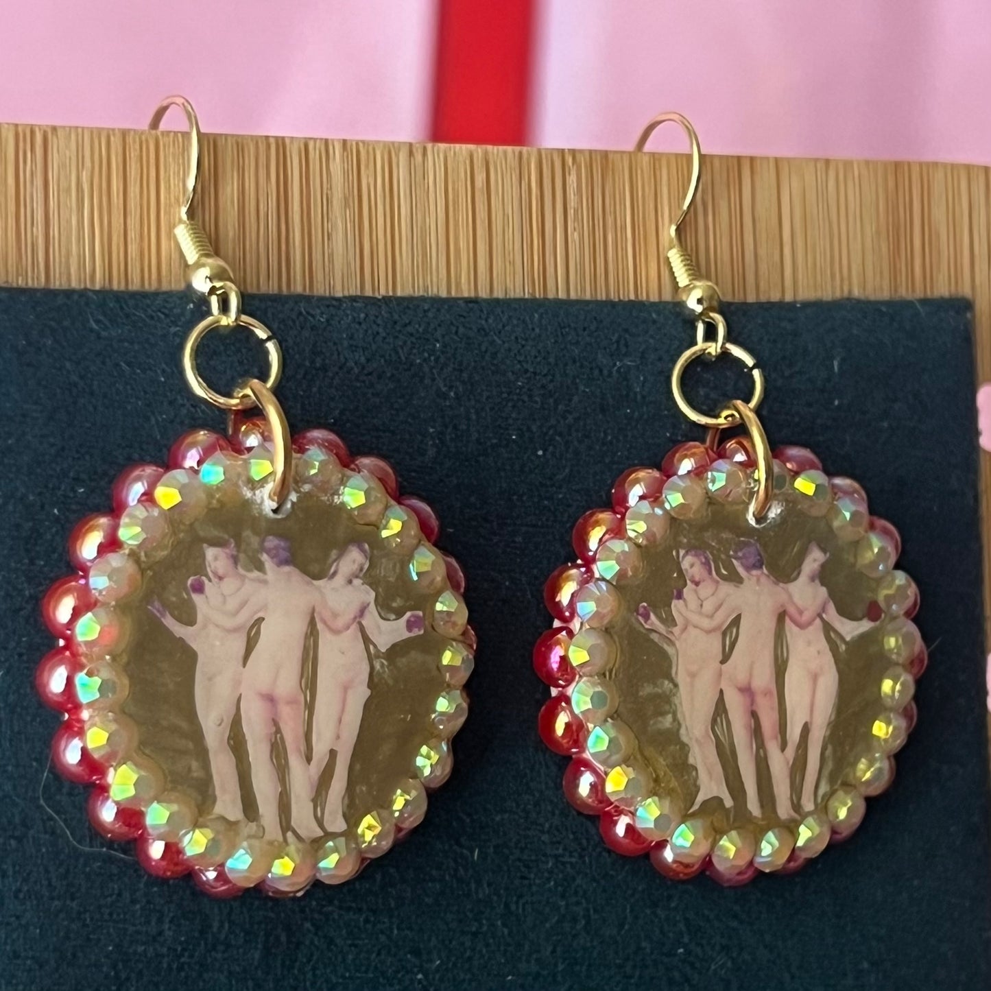 Handmade Three Graces gold earrings: metallic gold‑painted polymer clay framed with iridescent pearls and rhinestones, featuring hypoallergenic 18k gold‑plated hooks—perfect fairy‑core, goddess‑core, statement piece for lovers of Greek mythology jewelry.