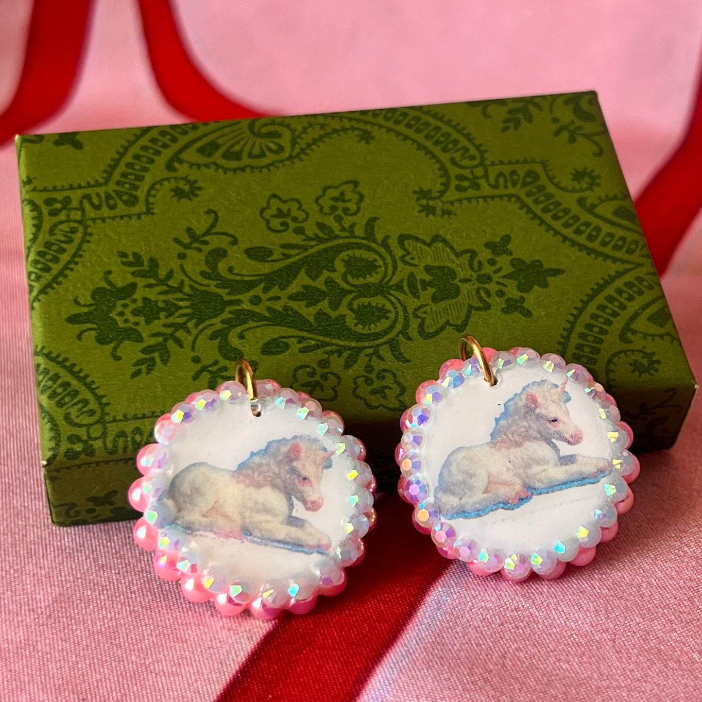 Alt text: "Handmade unicorn earrings featuring a pastel polymer‑clay charm with a soft fairy‑core unicorn, bedazzled by iridescent pink pearls and white gems, set in a gold‑plated fishhook finding; a whimsical, sparkly dangle earring perfect for Y2K, coquette, and pastel jewelry styles."