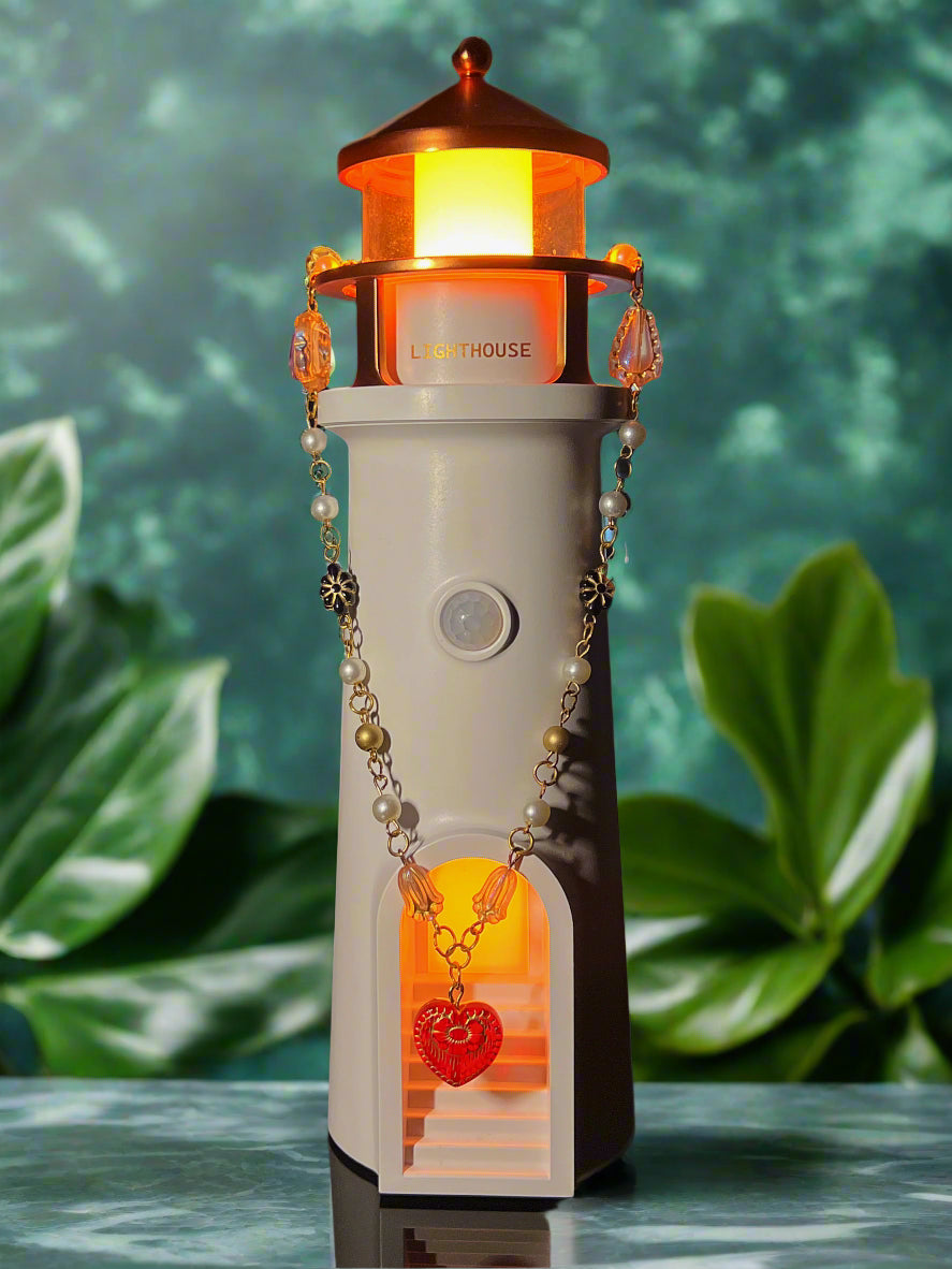 Decorative lighthouse-shaped lamp with a warm glow on a dark background