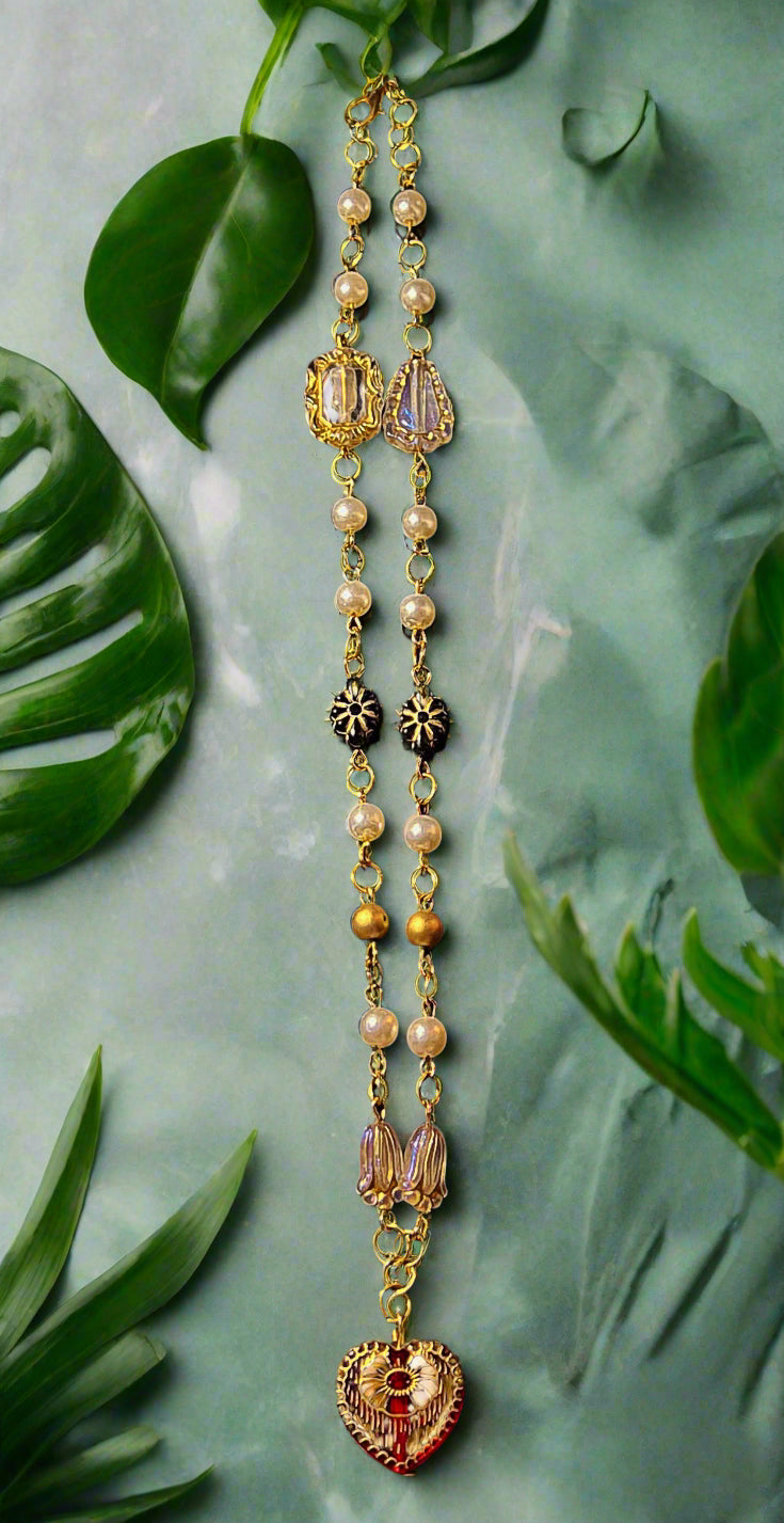 Long necklace with gold and pearl beads on a black background