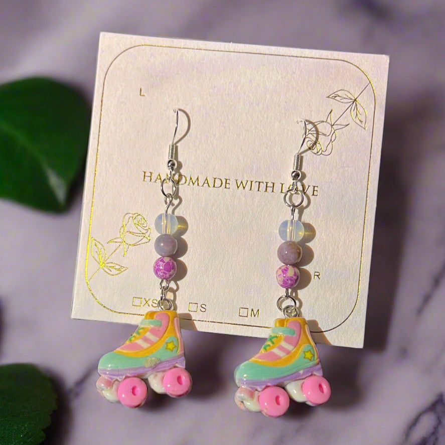Colorful roller skate earrings on a card with 'Handmade with Love' text.