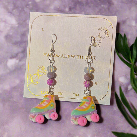 Pastel roller skate earrings on a card with 'Handmade with Love' text.