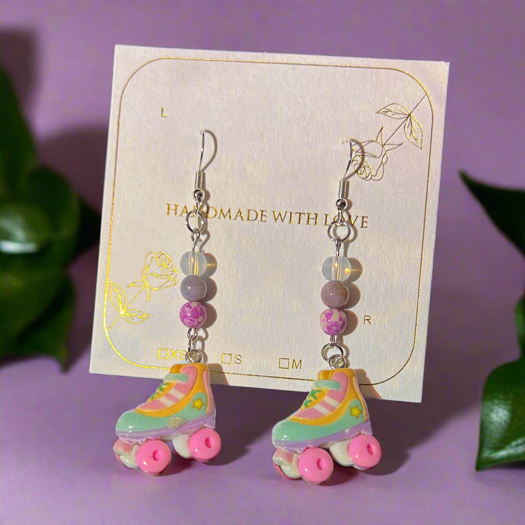 Colorful roller skate earrings on a card with 'Handmade with Love' text.