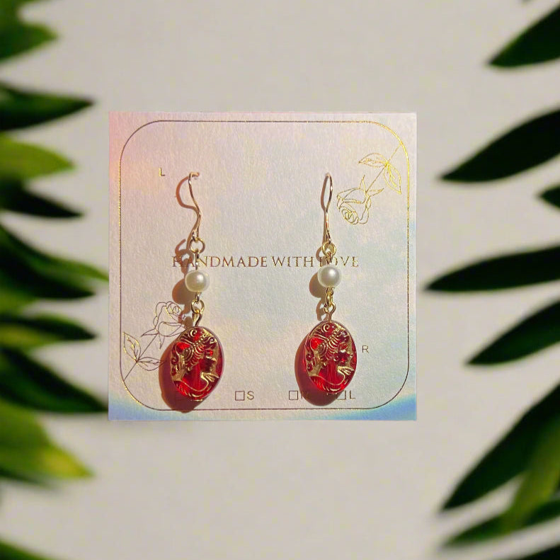 Card with earrings on a dark background
