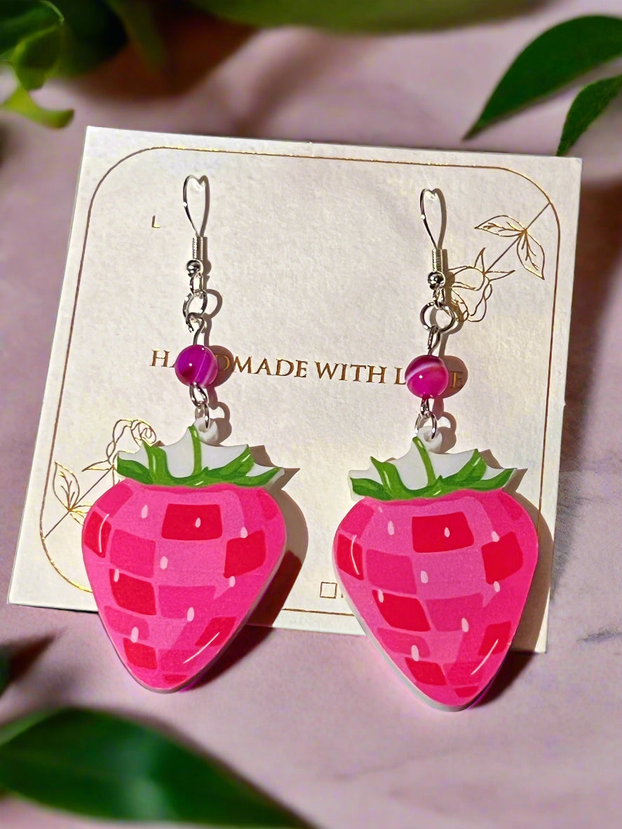 Strawberry-shaped earrings on a card with 'Handmade with Love' text.