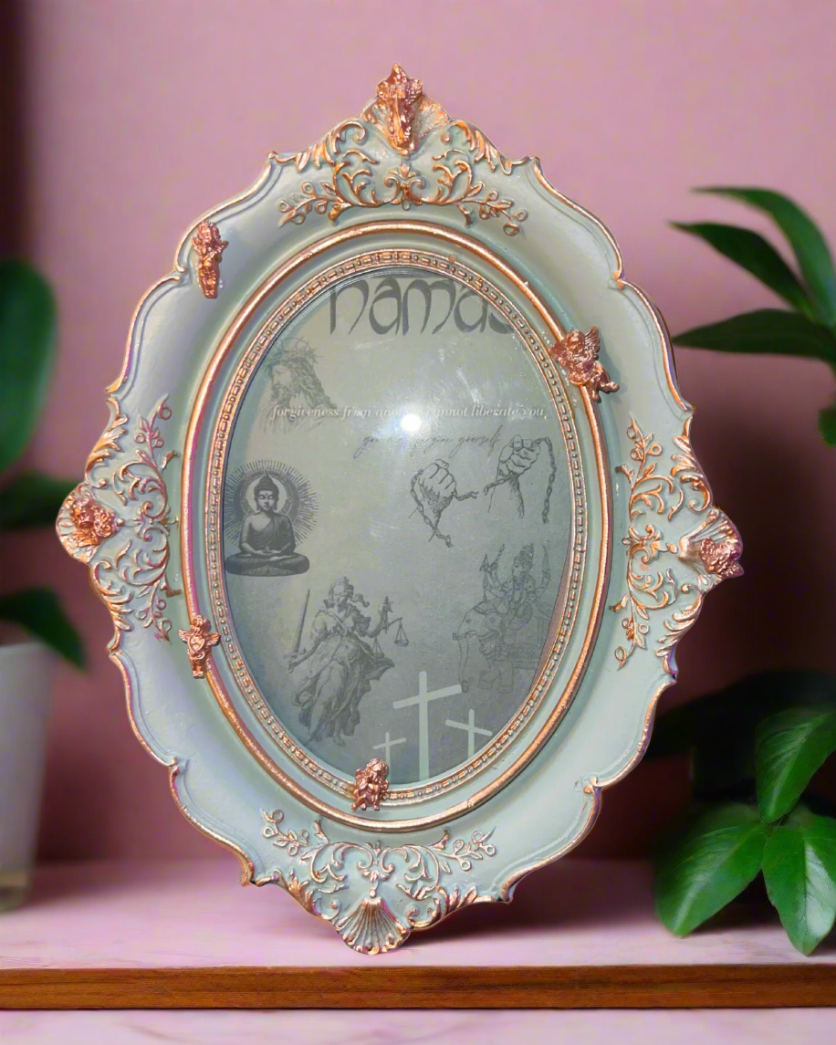 Decorative mirror with intricate frame and engraved text on a white background