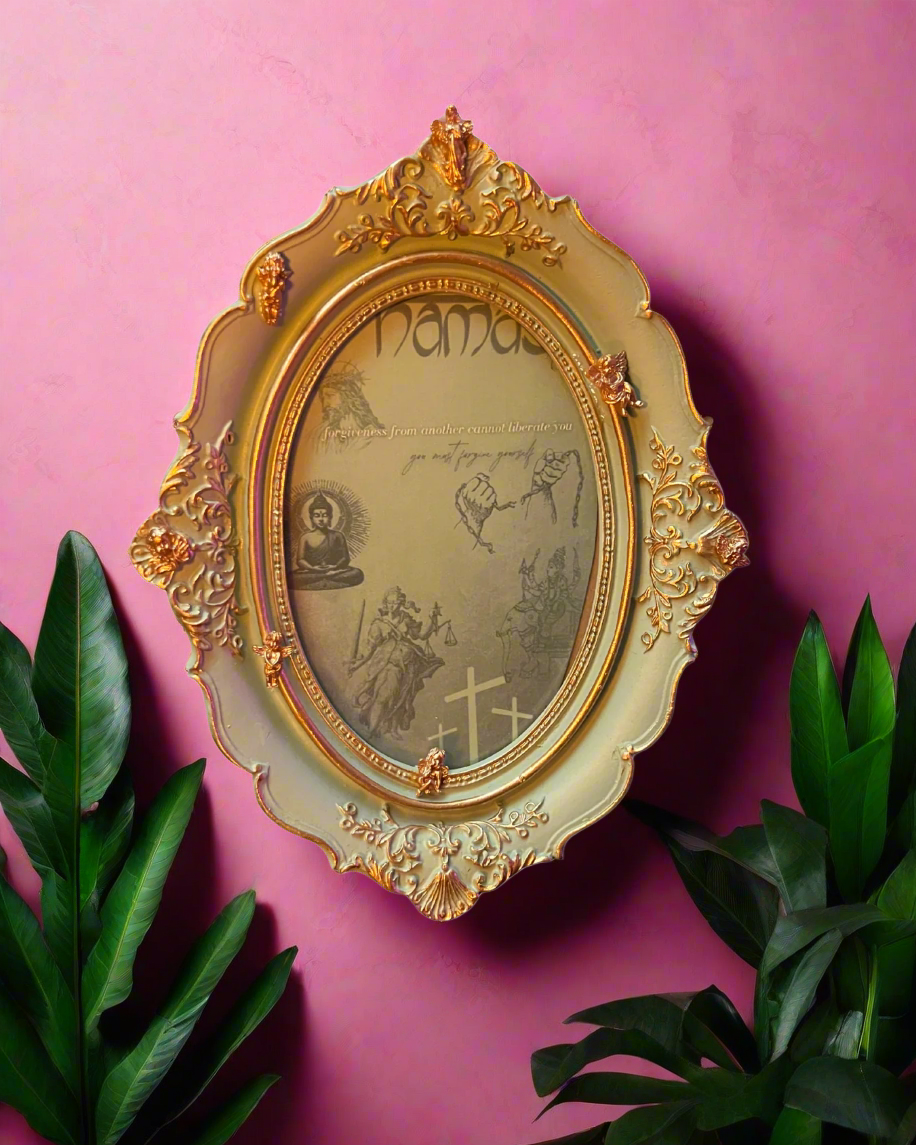 Decorative gold frame with intricate designs on a pink background
