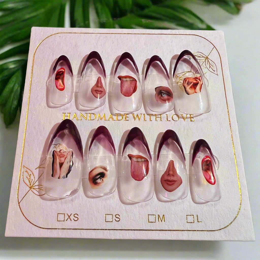 Set of handmade nail art designs on a display card with a decorative background.